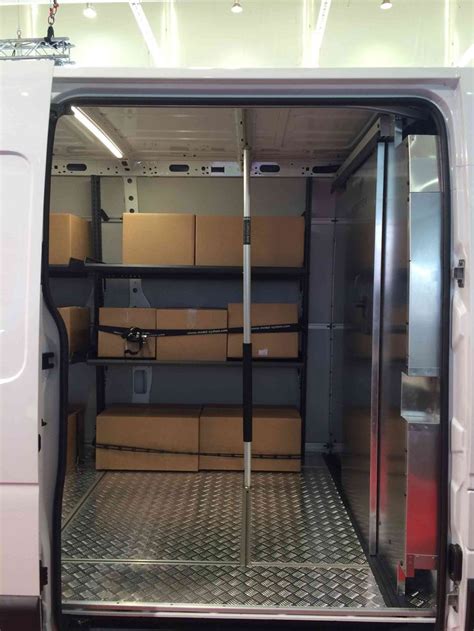 The Inside Of A White Van With Boxes In Its Back Door And Shelves