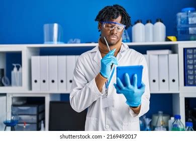 African American Man Scientist Using Touchpad Stock Photo