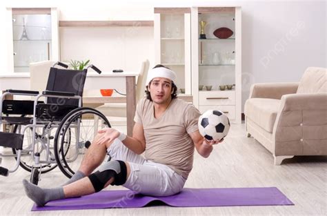 Injured Young Man Doing Exercises At Home Photo Background And Picture ...