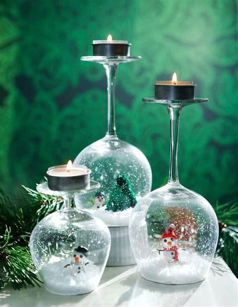 Three Glass Vases Filled With Snow Sitting On Top Of A Table Next To