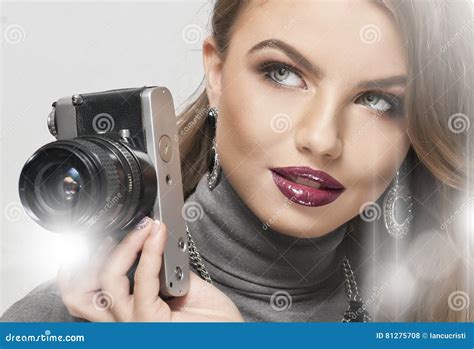 Blonde Girl With Camera Looking Forward Beautiful Blonde Girl With Black Retro Camera In Studio