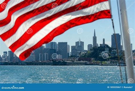 American Flag Waving On San Francisco Downtown Background View From