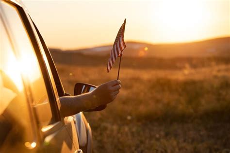 Premium Photo Mans Hand Holding A Waving American Usa Flag