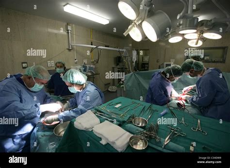 Doctors performing organ transplant surgery in hospital operating room ...