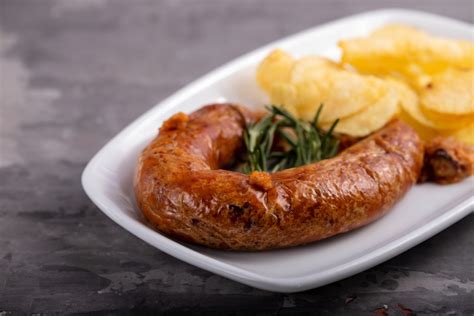 Typical Portuguese Smoked Sausage Alheira With Potato Chips On White