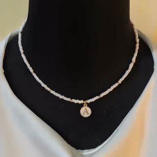 𝐒𝐁𝐒 𝐉𝐄𝐖𝐄𝐋𝐑𝐈𝐄𝐒 Letter Charmed Beaded Necklaces White Nude Beads with White Nude Pendant Shopee