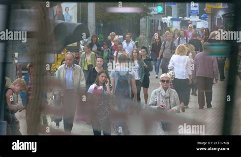 Crowd Of People Walking Along Busy Street In Summertime Stock Video