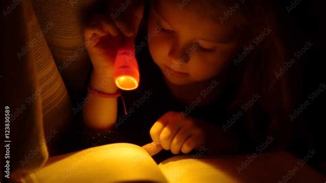 Girl reading under the covers with flashlight. Child Reading In Bed ...