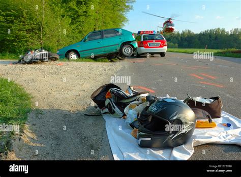 Scene Of A Car And Motorcycle Accident Rescue Helicopter Lifting Off Carrying A Female Victim