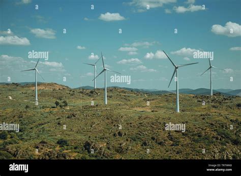 Wind Turbines For Electric Power Generation Over Hilly Landscape At