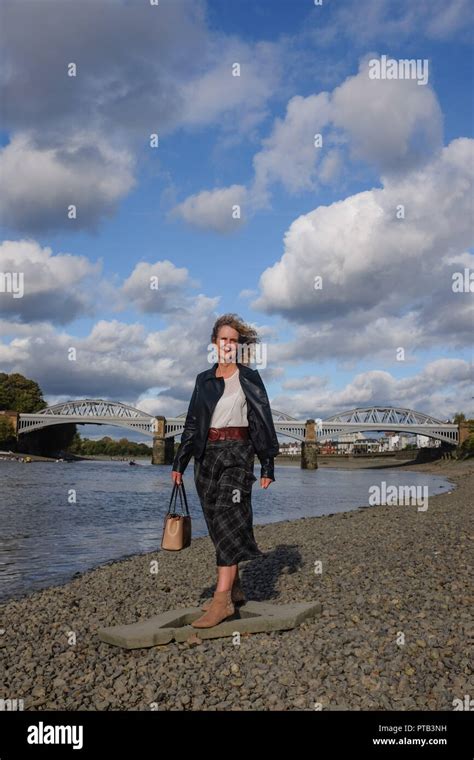 Mature Middle Aged Woman In Autumn Fashion Clothes By The River Thames