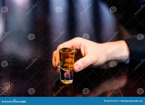 Man Holding A Shot Stock Photo Image Of Hand Male Indoors 66153124