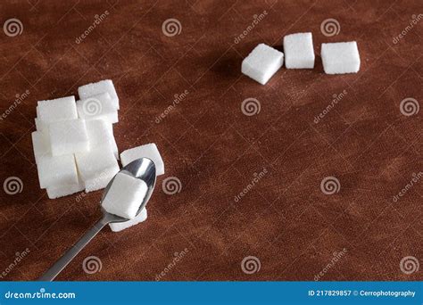 Sugar Cubes With Spoon Top View On Brown Natural Colored Background