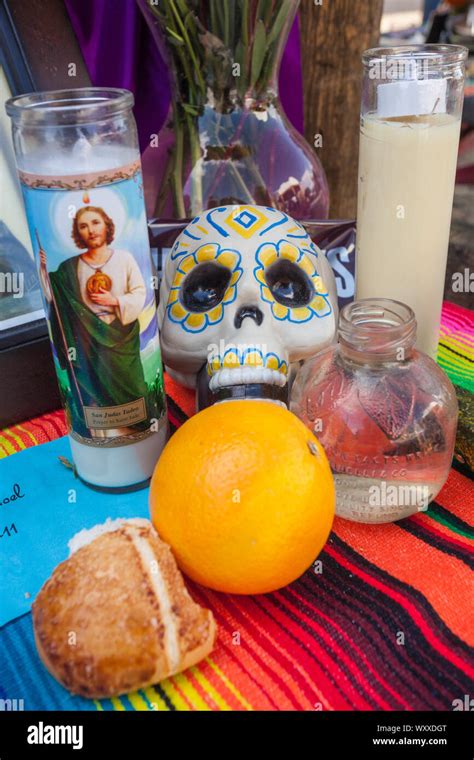 An Altar Featuring Colourful Sugar Skulls Calaveras Candles And Fruit At The Dia De Los