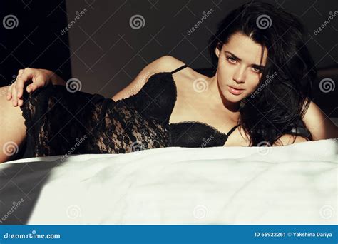 Woman With Dark Hair In Lace Lingerie Dress Lying In Bed In The Morning