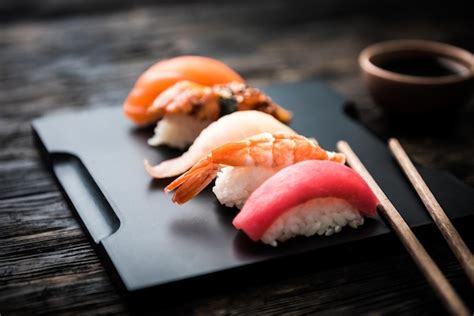 Premium Photo Close Up Of Sashimi Sushi Set With Chopsticks And Soy