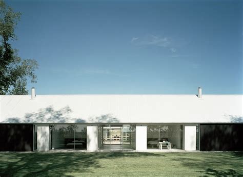 A White Building With Black Doors And Windows