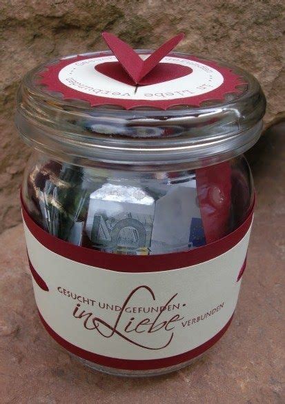 A Jar Filled With Assorted Items Sitting On Top Of A Stone Floor Next