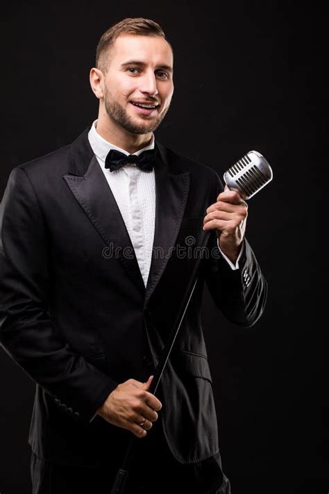 Young Man In Suit Singing Over The Microphone With Energy Stock Image