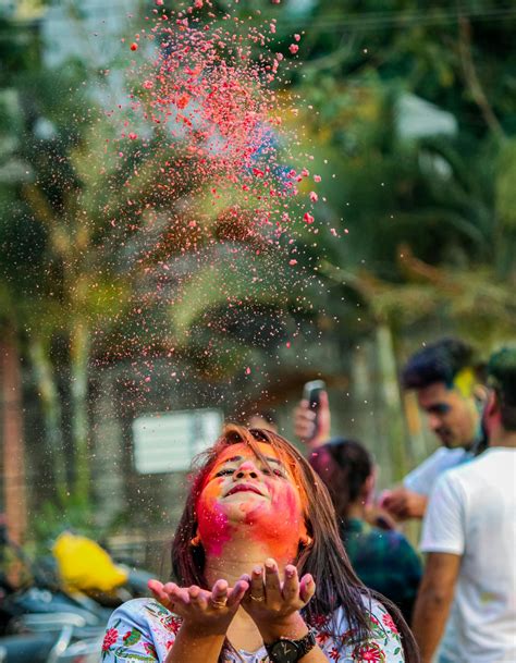 Indian Woman With Painted Face Throwing Holi Paints In Air · Free Stock