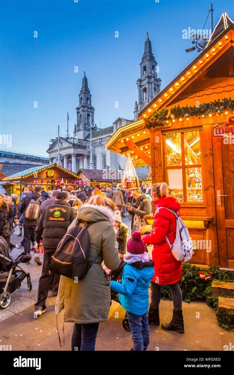 View of visitors and Christmas Market stalls at Christmas Market, Millennium Square, Leeds ...