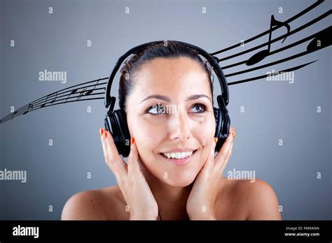 Beautiful Girl With Headphones And Musical Notes Flying On Grey