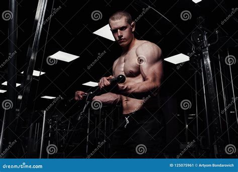 Brutal Strong Athletic Man Pumping Up Muscles Muscular Bodybuilder With Naked Sport Torso Doing
