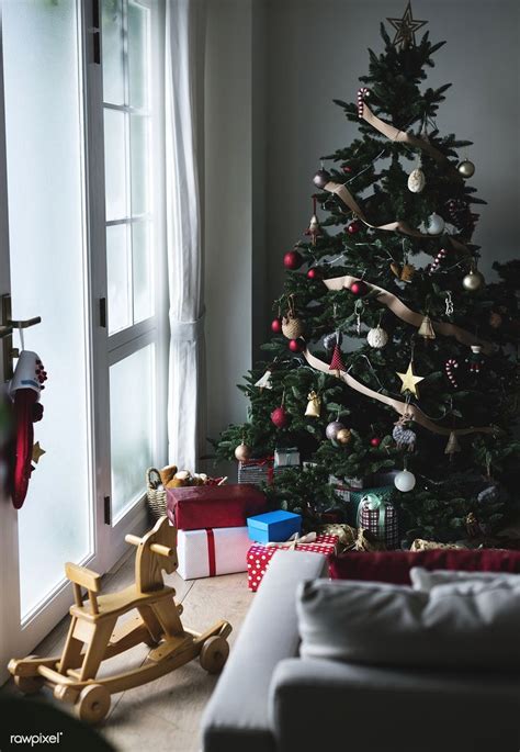 a decorated christmas tree in the corner of a living room