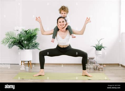 Mother and son doing fitness yoga exercise at home. Charming family ...