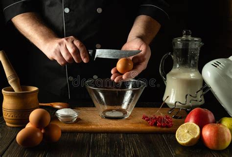 The Cook Prepares An Egg Omelette With Milk In The Kitchen Of A Breakfast Restaurant Work