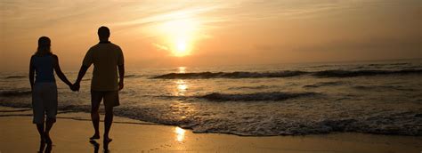 Couple On The Beach Holding Hands At Sunset Goldberg