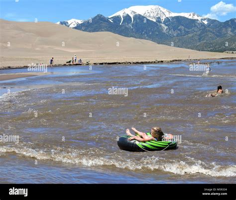 Girl Tubing Medano Creek Stock Photo - Alamy