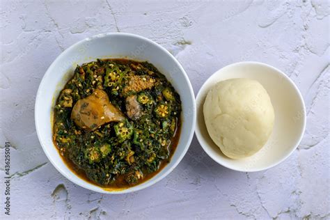 Okra soup served with fufu / pounded yam Stock Photo | Adobe Stock