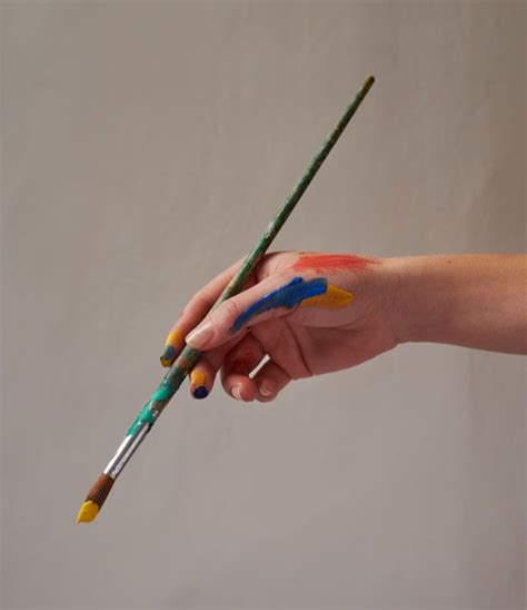 A Hand Holding A Paintbrush Paint Brushes Photography Artist