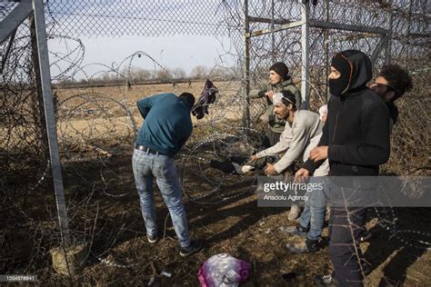 Irregular migrants cut down the iron wires as they continue to wait ...