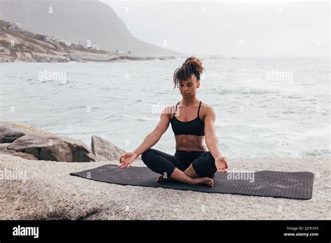 Woman Meditating On Mat Female With Crossed Legs Practicing Yoga By
