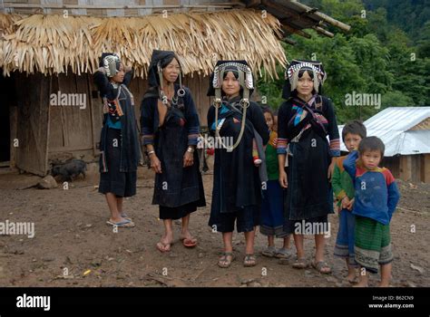 Four Women Of The Akha Phixo Tribe In Traditional Costume With Children