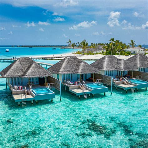 maldives-beach-huts-on-pristine-blue-water - Travel Off Path