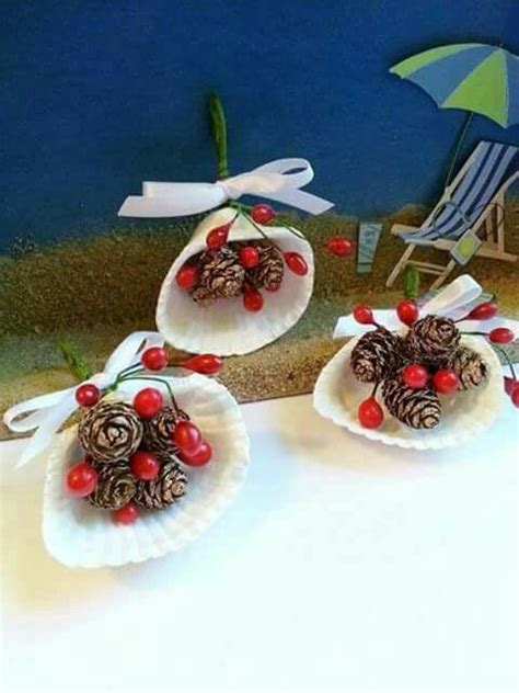 Two Pine Cones With Berries On Them Are Sitting In Paper Plates One Is