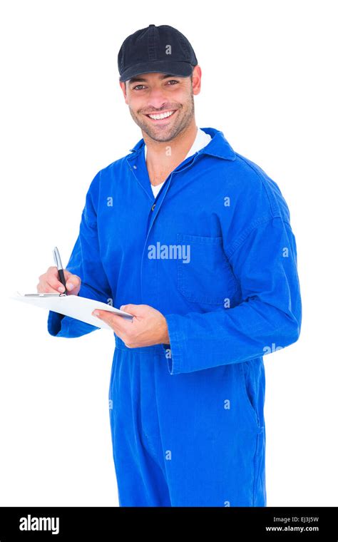 Handyman In Blue Overall Writing On Clipboard Stock Photo Alamy