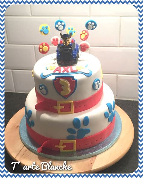 A Three Tiered Cake With Paw Patrol On Top