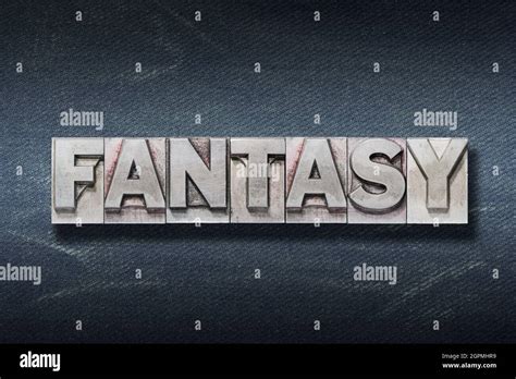 Fantasy Word Made From Metallic Letterpress On Dark Jeans Background