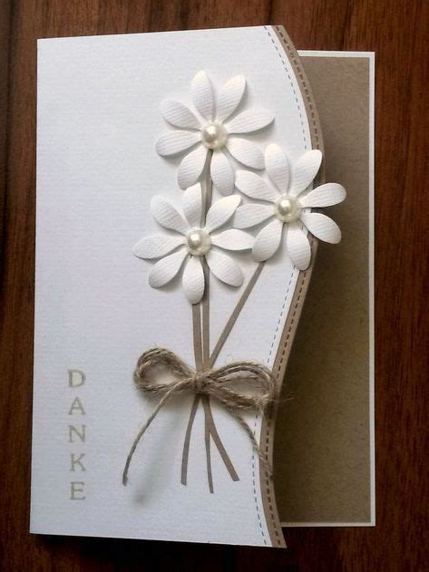 A White Card With Some Flowers On It