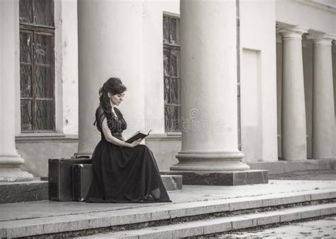 Beautiful Girl In Black Evening Dress Sitting Reading A Book A Girl