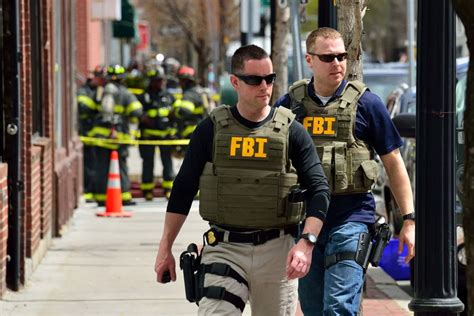 Download Two Fbi Agents Walking Down A Street