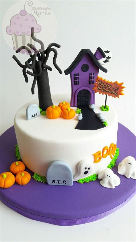 A Cake Decorated With Halloween Decorations On Top Of A Purple Plate