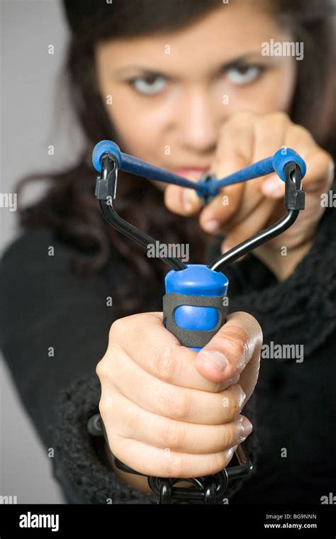 beautiful young brunette with blue slingshot Stock Photo - Alamy