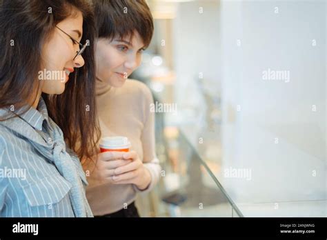 Pretty Blonde Girl Choosing Dessert From Glass Showcase In Bakery Shop