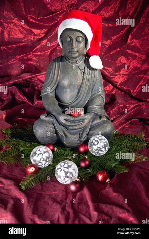 buddha statue with Santa Claus cap and Christmas decorations Stock ...