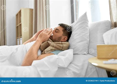 Sick Man Blowing Nose Lying In Bed At Home Stock Image Image Of Male